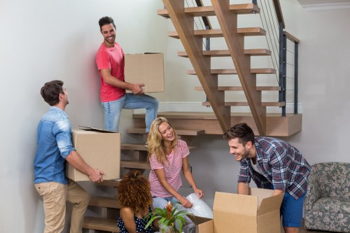 Man with van loading furniture into a moving vehicle