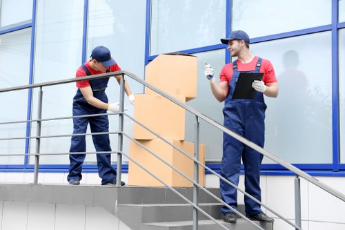 Moving team loading household items into a removal van