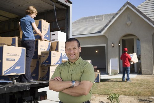 Movers carrying furniture into a Croydon property