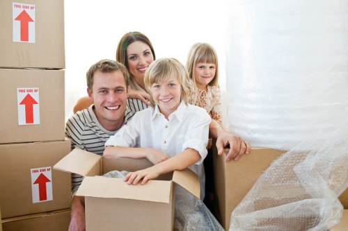 Professional movers carrying furniture down stairs