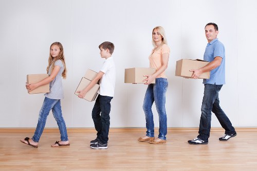 Moving team handling furniture and boxes on a Croydon street